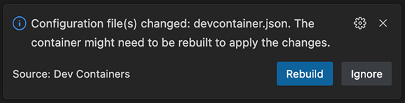 Devcontainer dialog indicating the container needs rebuilding with options to rebuild or ignore